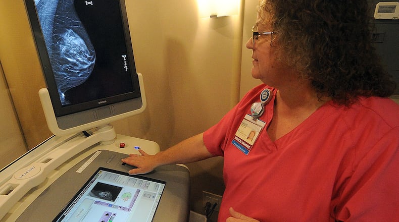 Shelly Robinson, mammographer for Premier Health mobile mammography coach, pulls up a 3-D scan. Breast cancer is the leading cause of cancer deaths in women under 50 years old. MARSHALL GORBY\STAFF