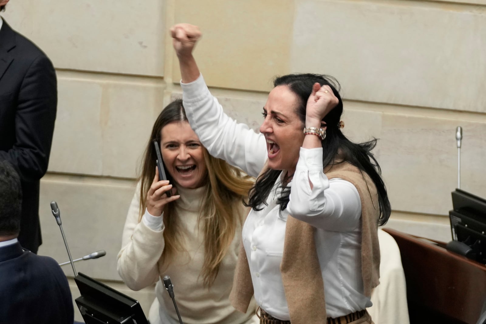 Opposition Senators Paloma Valencia, left, and Maria Fernanda Cabal celebrate after voting against a labor reform referendum proposed by the government, in Bogota, Colombia, Wednesday, May 14, 2025. (AP Photo/Fernando Vergara)