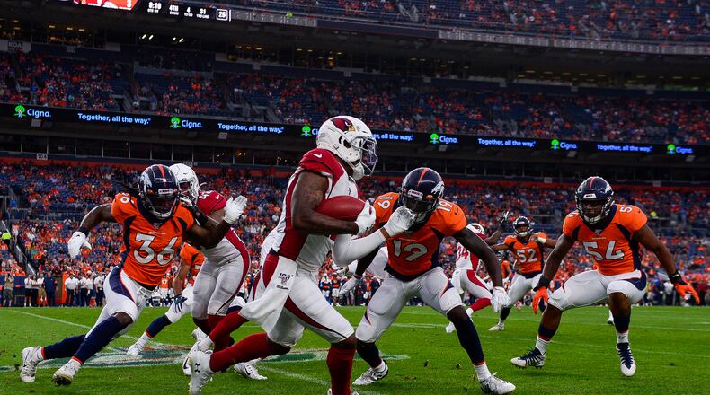 DENVER, CO - AUGUST 29: Pharoh Cooper #12 of the Arizona Cardinals is forced out of bounds by Fred Brown #19, Trey Marshall #36, and Josh Watson #54 of the Denver Broncos during the first quarter of a preseason National Football League game at Broncos Stadium at Mile High on August 29, 2019 in Denver, Colorado. (Photo by Dustin Bradford/Getty Images)