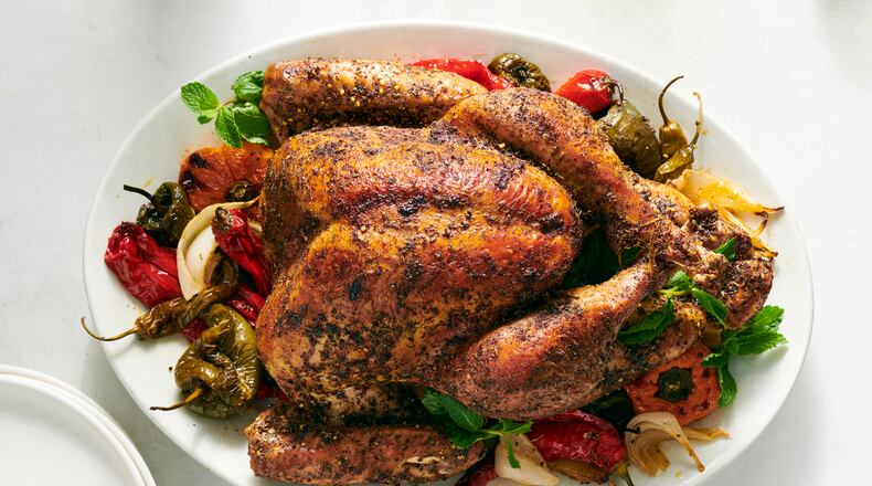 Dry-brined Thanksgiving turkey with chiles. Peppers and onions roasted along with the turkey make for a no-fuss side dish. Food styled by Simon Andrews. (David Malosh/The New York Times)