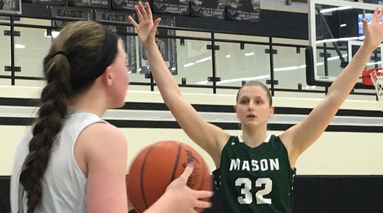 Mason’s Sammie Puisis (32) awaits the inbound pass by Lakota East’s Jessica Motley during Wednesday night’s game at East. RICK CASSANO/STAFF