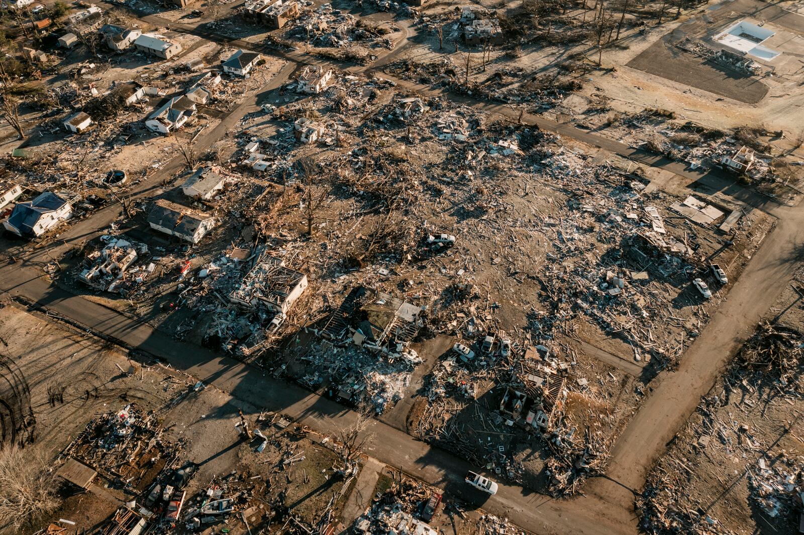 A heavily damaged neighborhood in Dawson Springs, Ky., on Monday, Dec. 13, 2021, where a tornado flattened much of the town on Friday night. After grimly fluctuating death tolls since Friday’s devastating swarm of tornadoes, Gov. Andy Beshear of Kentucky said on Monday that there were 64 confirmed deaths in the state, though he expected that number to rise as crews continued to search through the ruins. (William Widmer/The New York Times)