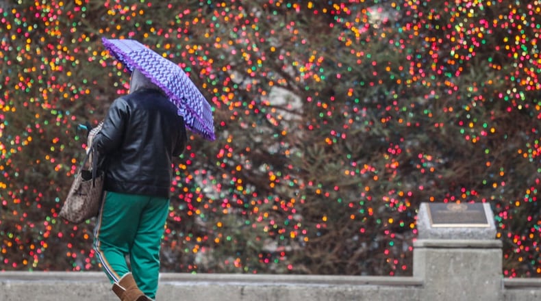 The Courthouse Square Christmas tree in Dayton glows brightly on a rainy and cold Monday Dec. 21, 2020. It is also the winter solstice, the longest night of the year and the official start of winter. Jim Noelker/Staff