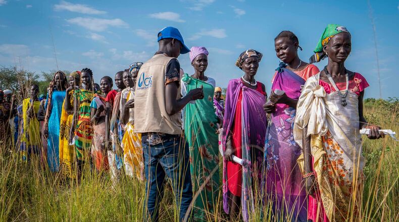 FILE - South Sudanese women line up for food rations at a World Food Programme (WFP) distribution point organized by Catholic Relief Services in Jonglei state, South Sudan, Wednesday, Nov. 13, 2024. (AP Photo/Florence Miettaux, File)
