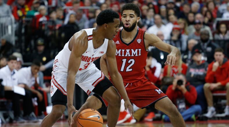 Ohio State’s C.J. Jackson, left, looks for an open pass as Miami’s Darrian Ringo defends during the first half of an NCAA college basketball game Saturday, Dec. 30, 2017, in Columbus, Ohio. (AP Photo/Jay LaPrete)