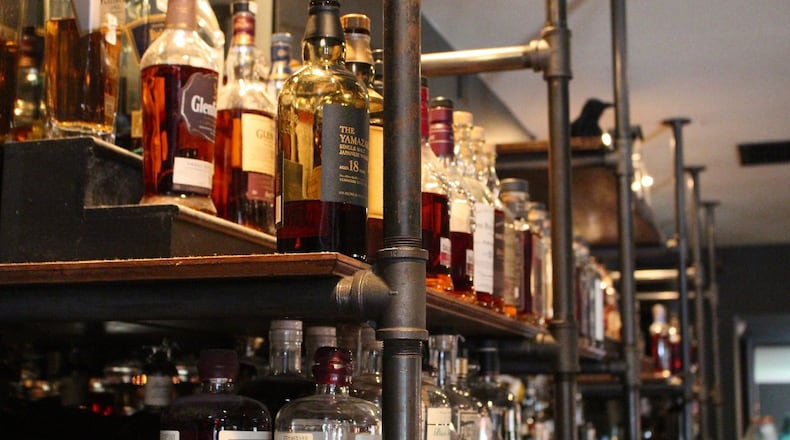 The back bar at Swift’s Attic carries more than 100 different whiskeys, ranging from bourbon to Japanese whisky to Scotch and more.