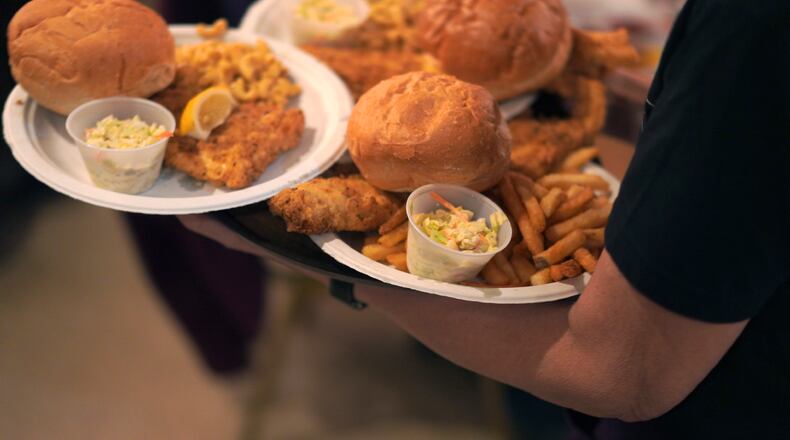 As more fish is consumed, the Montgomery County Environmental Services Commission warns individuals, restaurants and organizations to not pour used grease after frying fish down drains. Pictured is a file photo of plates of fried fish and sides during the Allegheny Elks Lodge #339 annual fish fry in Pittsburgh on Friday, Feb. 24, 2023. (AP Photo/Jessie Wardarski)