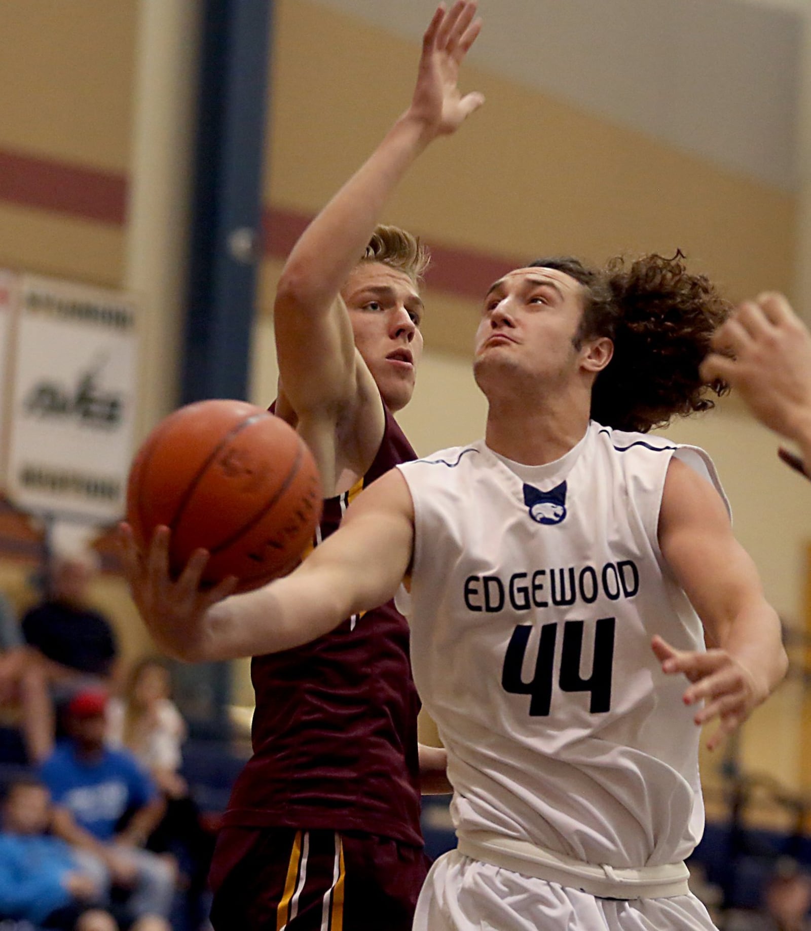 Edgewood’s Garrett Gabbard gets past Ross’ Landen Angel and eyes the basket Saturday during the inaugural All-Butler County All-Star boys basketball game at the Hamilton Athletic Center. CONTRIBUTED PHOTO BY E.L. HUBBARD