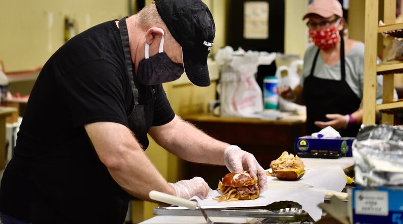 Alexander’s Market & Deli owner Les Rudisell prepares a sandwich at the eatery, which is one of 11 restaurants taking part in the inaugural Hamilton Restaurant Week. The event starts Tuesday, May 5, 2020, and runs through and including Friday, May 8, 2020. NICK GRAHAM/STAFF