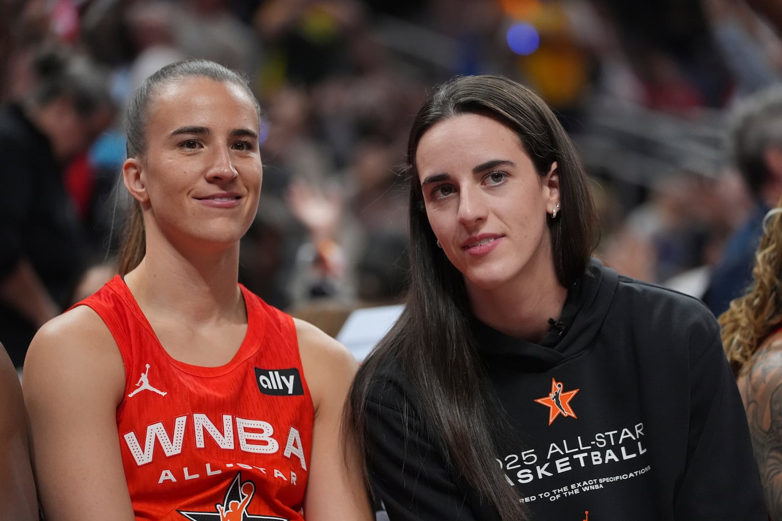 New York Liberty's Sabrina Ionescu, left, talks with Indiana Fever's Caitlin Clark during the second half of a WNBA All-Star basketball game against Team Collier, Saturday, July 19, 2025, in Indianapolis. (AP Photo/Michael Conroy)