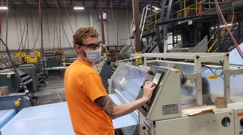 Employees of the West Chester Twp. location of packaging company Novolex work to create isolation gowns to be delivered nationwide to the epicenters of the COVID-19 pandemic. Production launched there April 13 and has since produced more than 1.5 million gown with millions of more on the way. CONTRIBUTED