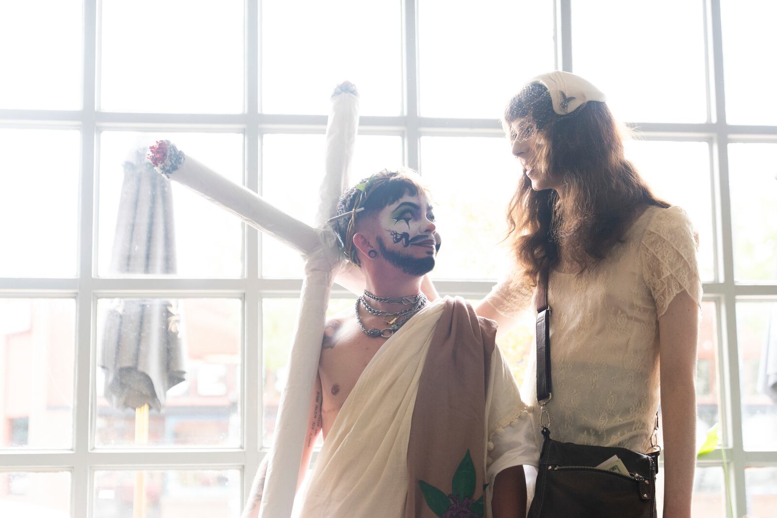 Drag performer Ed Du'Bull, left, looks up at their girlfriend Anna Quaintance after performing in a "blaze and praise" drag brunch at Bar Carlo on Sunday, April 20, 2025, in Portland, Ore. (AP Photo/Jenny Kane)