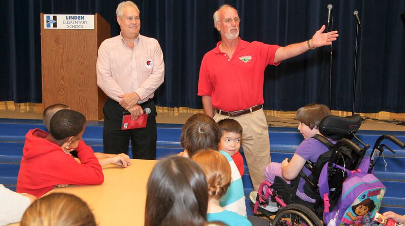 Kim Nuxhall, right, and Doug Coates, author of "Pitching for Success: Character Lessons, The Joe Nuxhall Way," talk to students at Linden Elementary school in Hamilton, Wednesday, May 14, 2014. Coates in March 2020 published his second book, “Riley’s Winning Catch,” and portions of the proceeds will benefit the Joe Nuxhall Miracle League and the Down Syndrome Foundation. GREG LYNCH/FILE