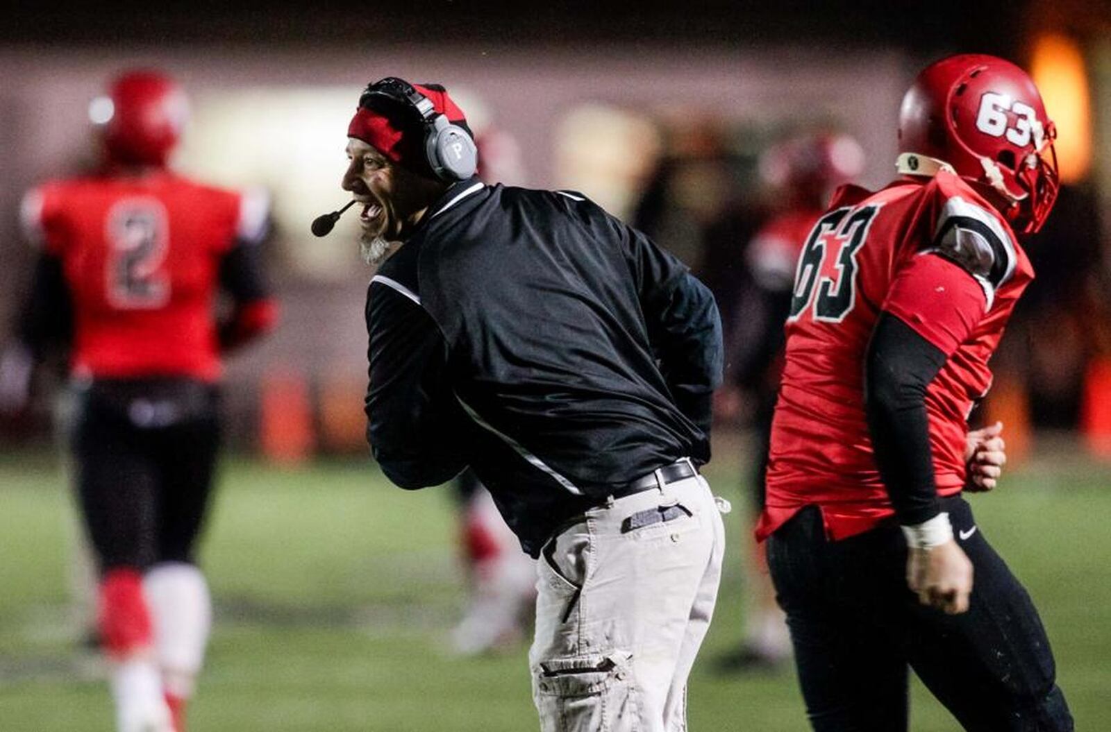 Madison High School assistant coach Jeff Rippl shows his excitement near offensive lineman Steven Ward (63) during last Friday’s 35-27 win over Cincinnati Hills Christian Academy in a Division V, Region 20 semifinal at Lakota East. NICK GRAHAM/STAFF