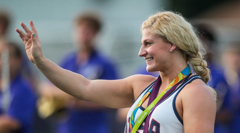 Kayla Harrison, two-time Olympic Gold Medalist in Judo, takes the field with her gold medals before the Middies game Friday, Sept. 9 at Barnitz Stadium in Middletown. NICK GRAHAM/STAFF