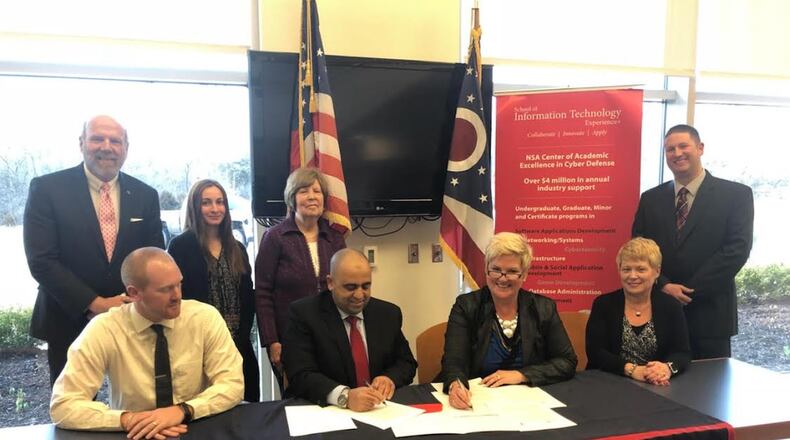 Shown at the signing of the contract to offer IT classes at Talawanda High School (THS) are (from left, seated) THS teacher Andy Zimmerman, University of Cincinnati Director of the school of Information Technology Hazem Said, Talawanda Superintendent Kelly Spivey and Talawanda Director of Teaching and Learning Joan Stidham; (back row) Director of the Ohio Cyber Range at UC Steve Smith, Project Manager at the UC School of Information Technology Lauren Kirgis and Talawanda STEM Instructional Leader Ryan Barter. CONTRIBUTED