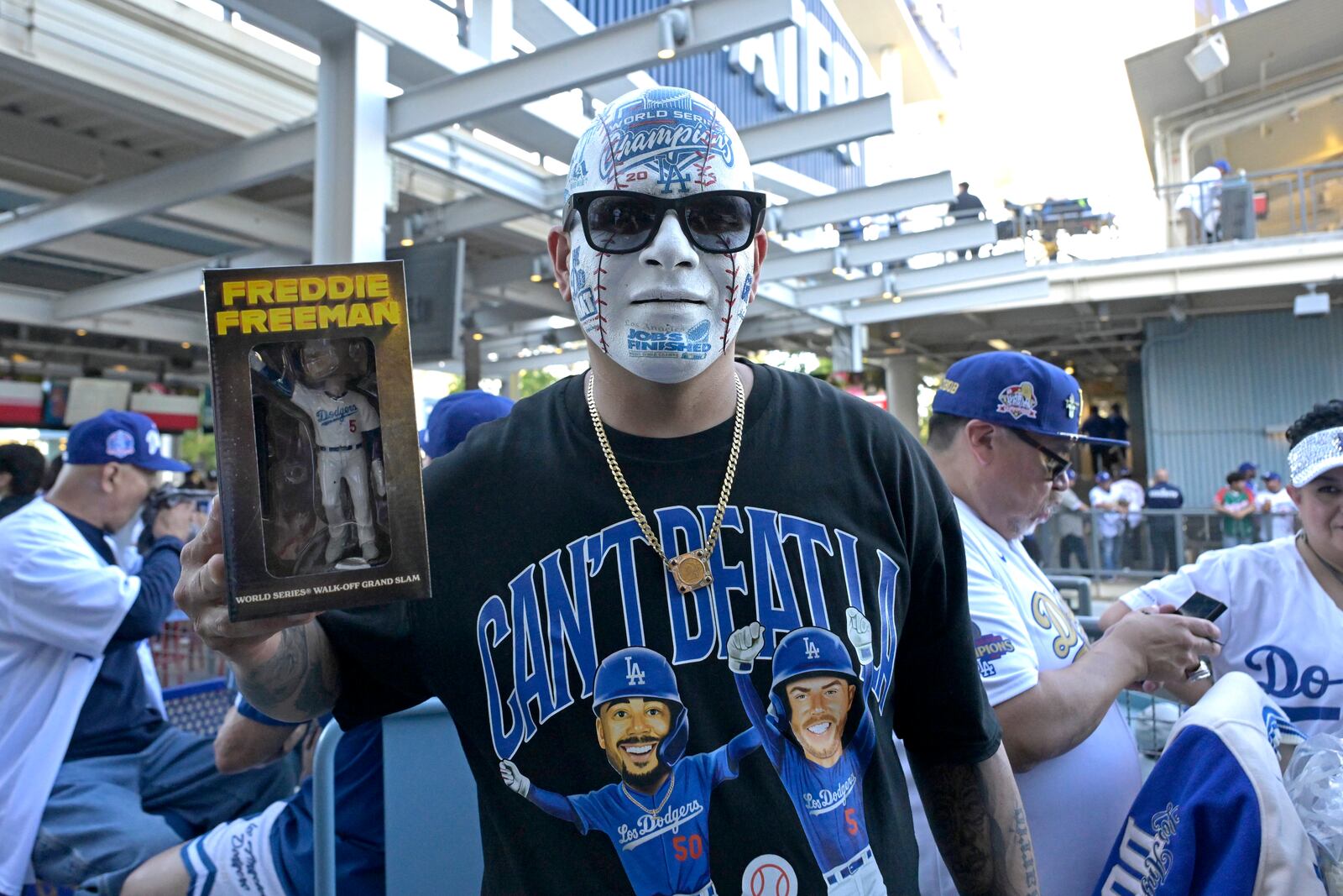 Los Angeles Dodgers fan Angel Rodriguez holds his Freddie Freeman bobblehead prior to a baseball game against the Chicago Cubs, Friday, April 11, 2025, in Los Angeles. (AP Photo/Jayne Kamin-Oncea)