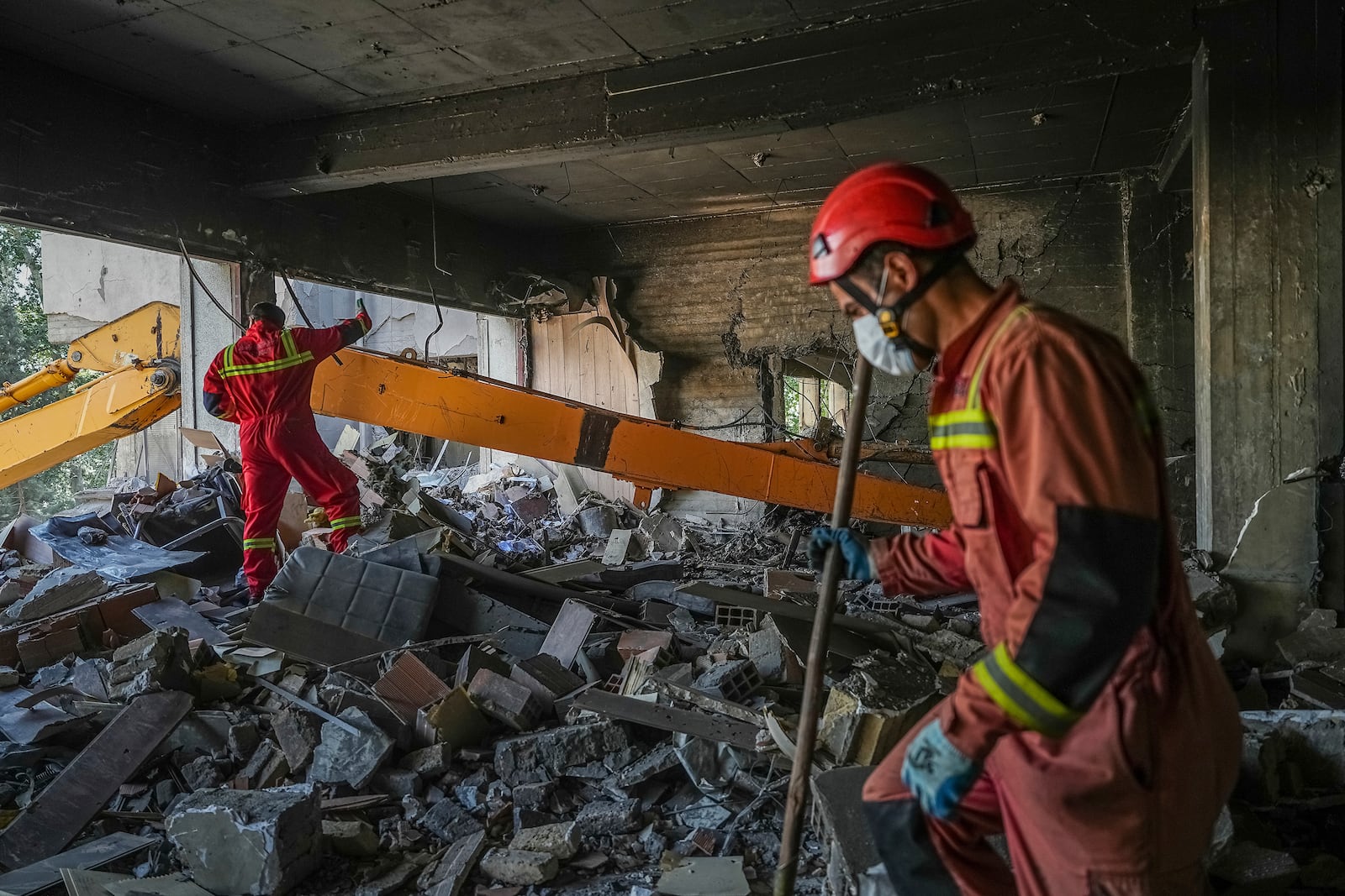 In this photo taken Tuesday, June 24, 2025, rescuers search through the rubble of a damaged section of Evin Prison following an Israeli strike the day before, in Tehran, Iran. (AP Photo/Mostafa Roudaki/Mizan News Agency)