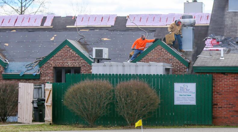 Workers from Roberts Roofing replace the roof of the clubhouse at Potter’s Park golf course in Hamilton on Feb. 15. The roof replacement is among upgrades happening before this year’s golf season is in full swing. The new roof will cost an estimated $30,000. The parking lot at Potter’s Park will also be resurfaced for $75,000. GREG LYNCH / STAFF