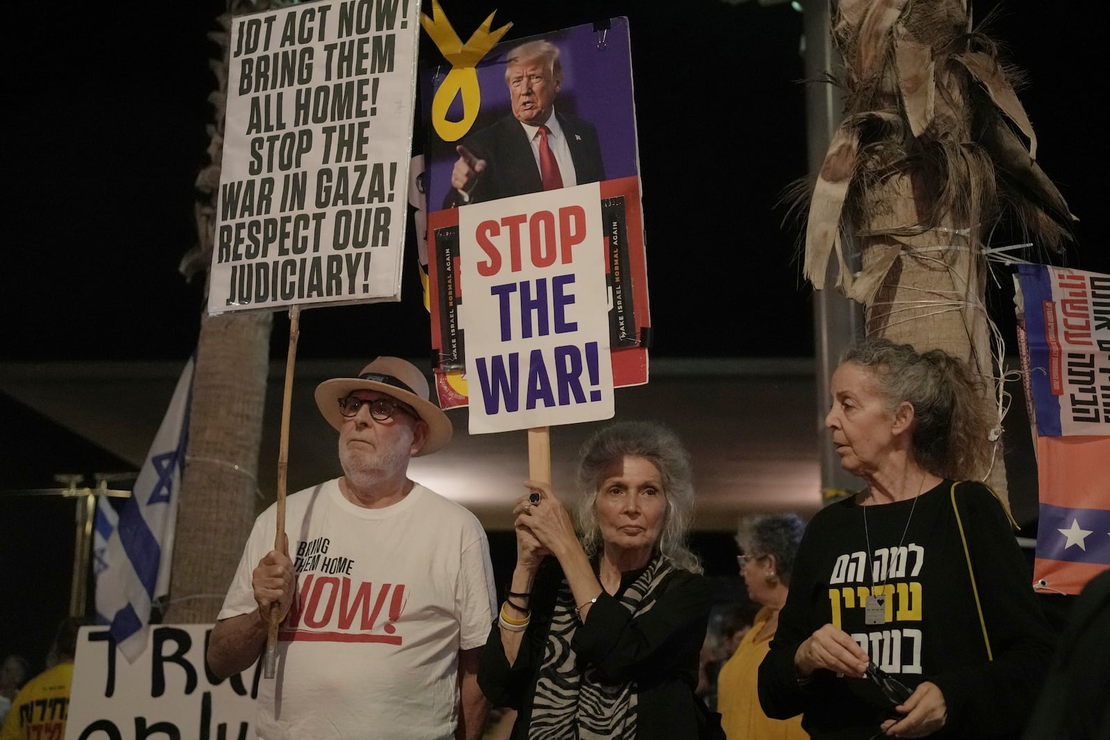 People take part in a protest outside US Embassy Branch demanding the end of the war and immediate release of hostages held by Hamas in the Gaza Strip, and against Prime Minister Benjamin Netanyahu's government in Tel Aviv, Israel, Saturday, July 19, 2025. (AP Photo/Maya Alleruzzo)