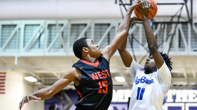 Lakota West’s Myles Greenwood defends a shot by Hamilton’s Bryan Henderson during their basketball game Friday, Jan. 5 at Hamilton High School. Big Blue won 60-34. NICK GRAHAM/STAFF