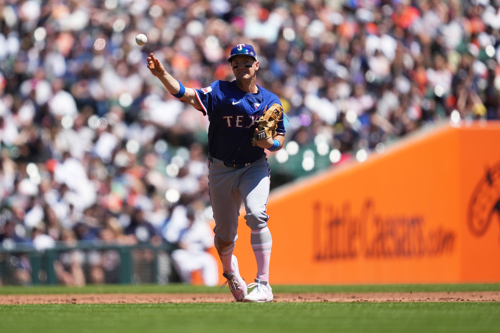 Texas Rangers third baseman Josh Jung throws to first base for an out on a Detroit Tigers' Zach McKinstry ground ball in the second inning during a baseball game, Sunday, May 11, 2025, in Detroit. (AP Photo/Paul Sancya)