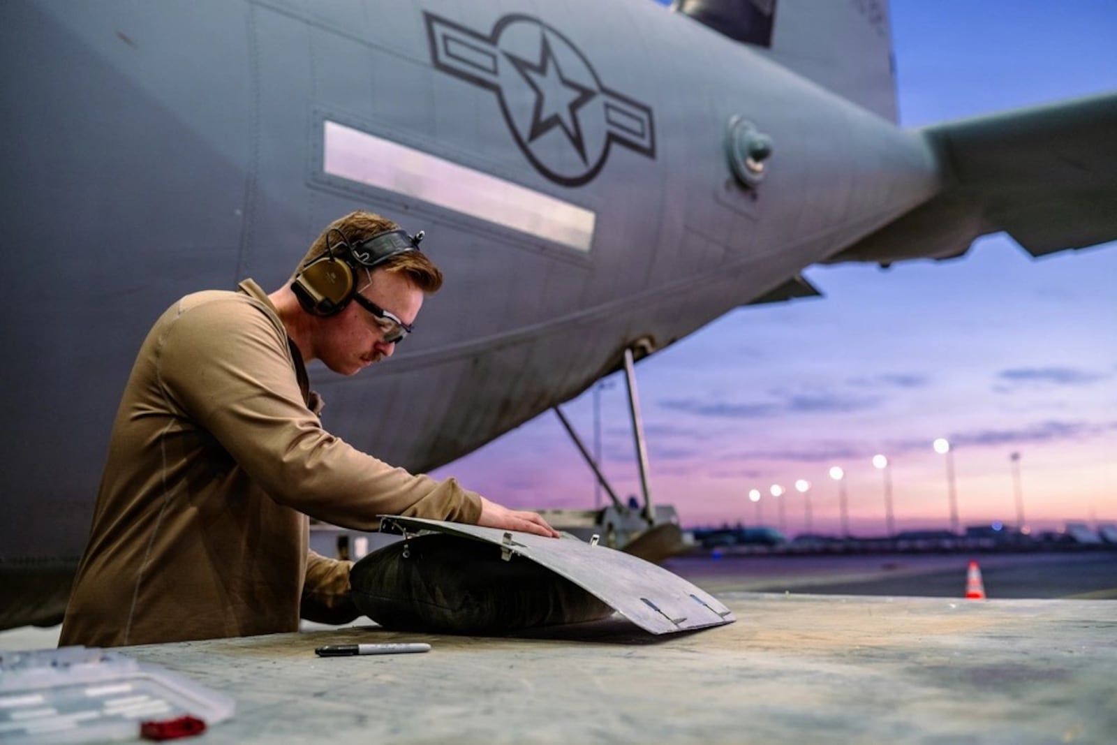 Air Force Staff Sgt. Andrew Pokojski, 61st Expeditionary Aircraft Maintenance Squadron aircraft structural maintenance technician, shapes a replacement panel on a C-130J Super Hercules within the U.S. Central Command area of responsibility, Jan. 5, 2026. Air Force photo by Staff Sgt. Tylin Rust