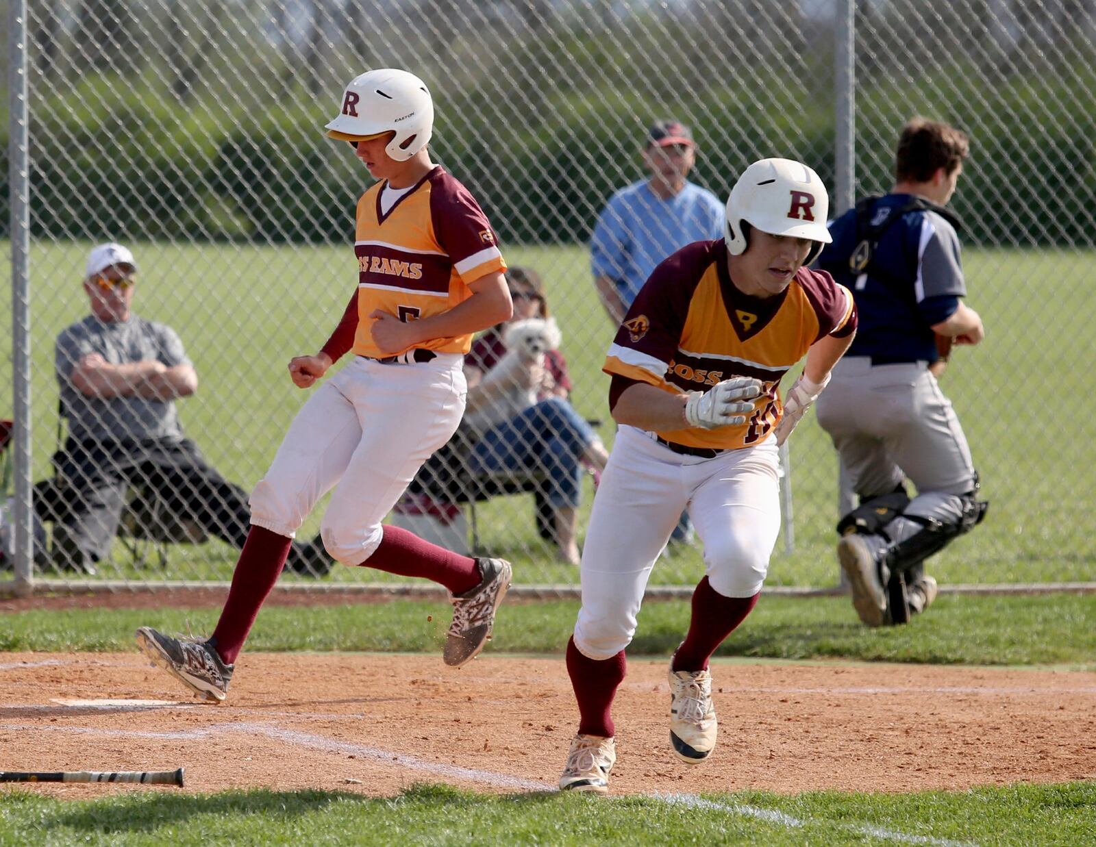 Ross runner Zach Evans scores as teammate Zach Arno tries to reach first on a third-strike passed ball during Wednesday’s game against visiting Edgewood. CONTRIBUTED PHOTO BY E.L. HUBBARD