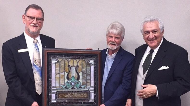 Carmon DeLeone, music director of the Middletown Symphony Orchestra, celebrated 35 years leading the orchestra and was presented with stained glass art created by Jay Moorman of Beauvre Stained Glass. Pictured left to right: Steve Ifcic, president of the board Middletown Symphony, Jay Moorman and DeLeone.
