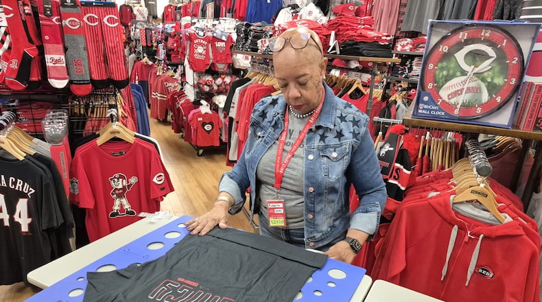 Sales associate Roberta Pitman folds merchandise at Rally House Dayton Mall. The store is hiring four positions for the holiday season. MICHAEL KURTZ / STAFF