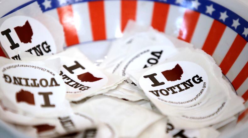 FILE - A bowl of stickers is set out for voter March 15, 2020, in Steubenville, Ohio. Ohio's scheduled primary election is just six weeks away, but candidates still don't know whether the voting contest will happen then. A series of court rulings invalidating Republican-drawn redistricting maps has threatened to delay the state's May 3 primary by a month or more. (AP Photo/Gene J. Puskar, File)