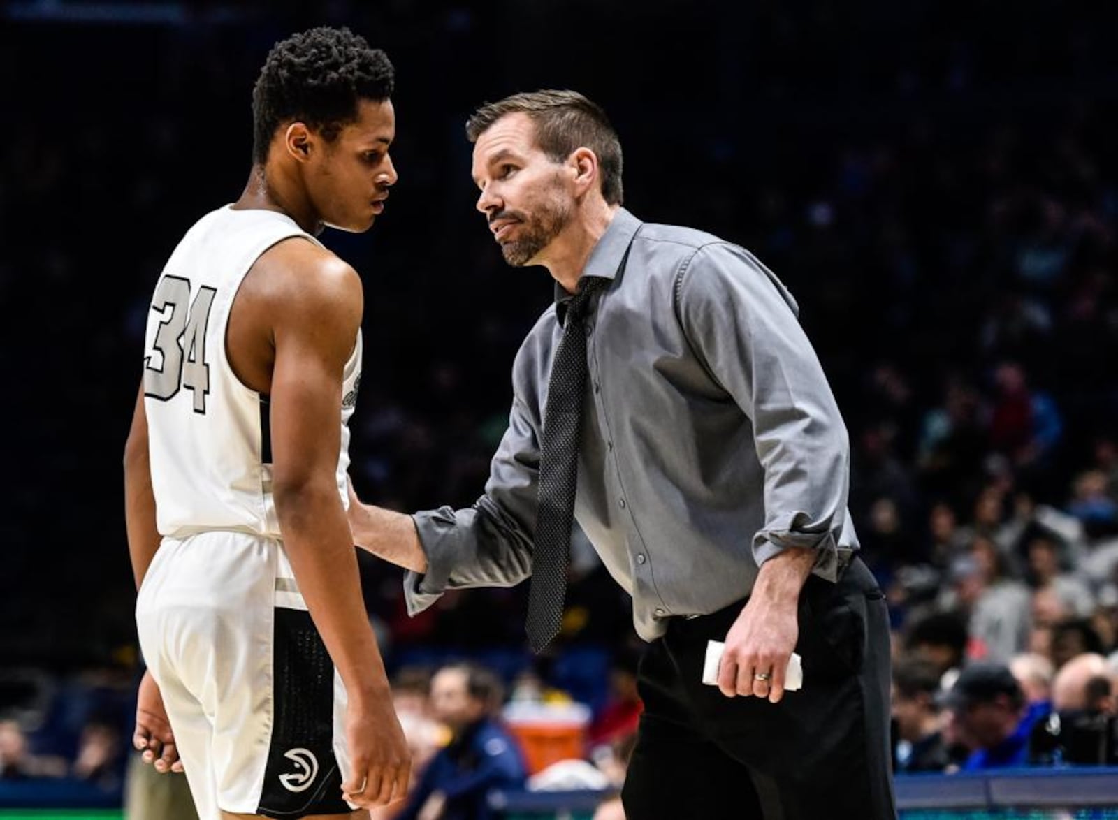 Lakota East coach Clint Adkins talks to Nate Johnson during a Division I regional basketball semifinal against Moeller on Wednesday night at Xavier University’s Cintas Center. Moeller won 47-33. NICK GRAHAM/STAFF