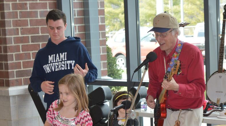 No library card is needed to check out an air guitar, and young library patrons joined the fun as Jim McCutcheon (aka “The Guitar Man”) entertained March 5 to kick off the library’s new musical instrument lending program. CONTRIBUTED/BOB RATTERMAN
