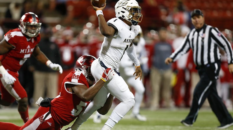OXFORD, OH - NOVEMBER 07: Kato Nelson #1 of the Akron Zips throws a pass under pressure from Ikeem Allen #55 of the Miami Ohio Redhawks during the second half at Yager Stadium on November 7, 2017 in Oxford, Ohio. (Photo by Michael Reaves/Getty Images)