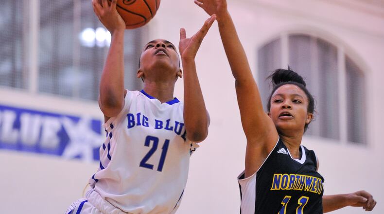 Hamilton’s CiCi Riggins puts up a shot defended by Northwest’s Anye’ Shabazz during their game Dec. 27, 2018, at the Hamilton Freshman School in Hamilton. NICK GRAHAM/STAFF