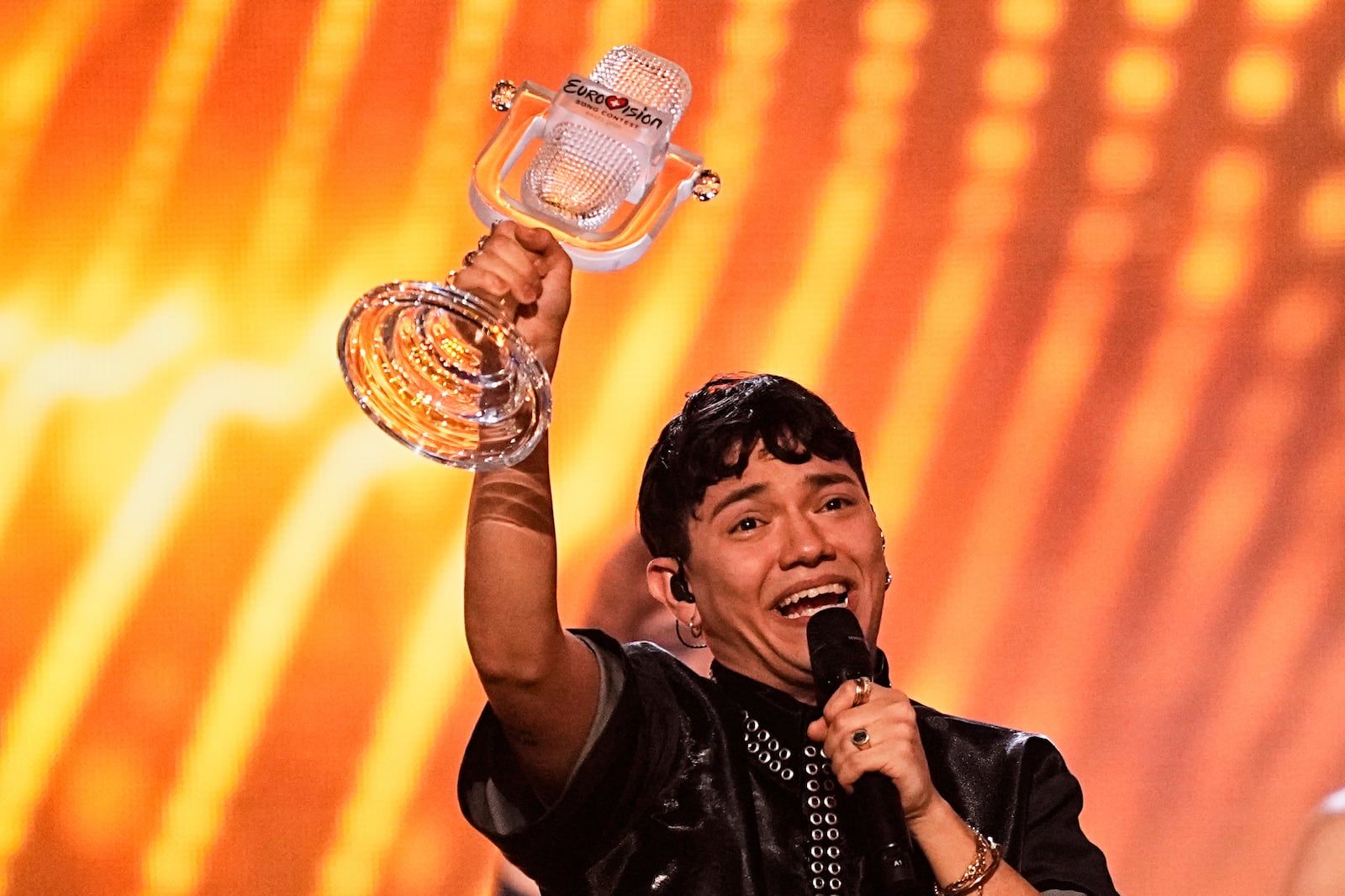 Winner of the Eurovision Song Contest JJ from Austria holds up the trophy onstage he won with the song "Wasted Love" during the Grand Final of the 69th Eurovision Song Contest, in Basel, Switzerland, Saturday, May 17, 2025. (AP Photo/Martin Meissner)
