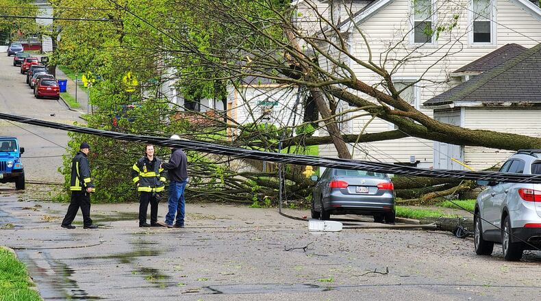 The results of an international tree survey, being partially conducted in Hamilton, Ohio, will determine some best practices when maintaining trees near power lines that will help reduce maintenance costs and the number of outages resulting from fallen trees. Pictured is a downed tree entangled in power lines at Liberty Avenue and North F Street in Hamilton after a May 3, 2022, storm. NICK GRAHAM/FILE