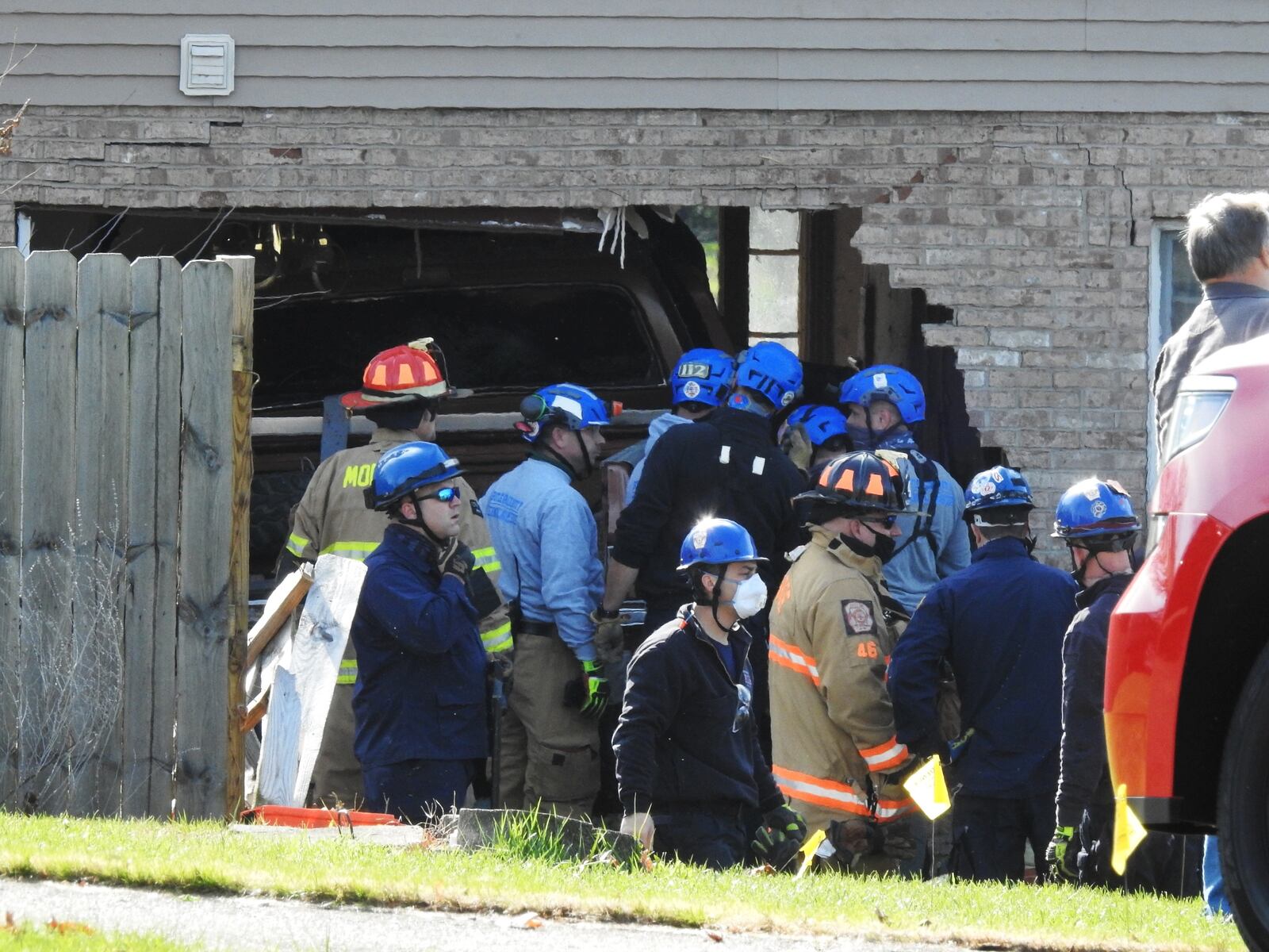 Emergency units work to remove a truck that slammed into a Monroe house this morning NICK GRAHAM/STAFF