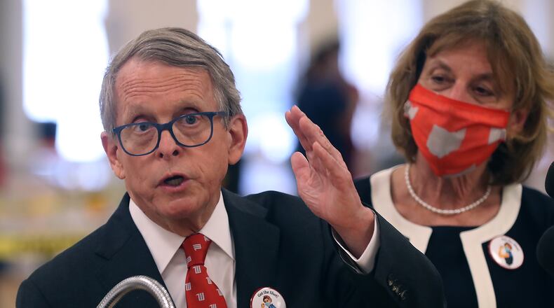 Governor Mike DeWine speaks to the media after touring the Clark County COVID vaccine distribution center with his wife, Fran, at the Upper Valley Mall Thursday. BILL LACKEY/STAFF