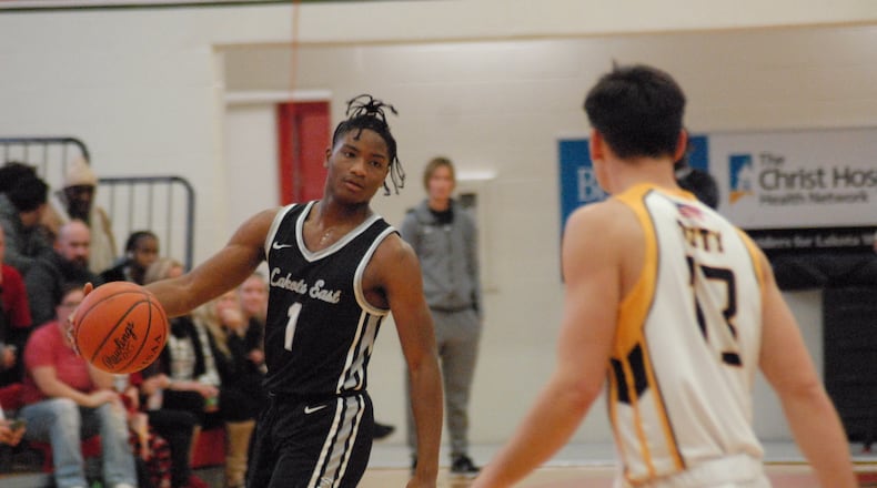 Lakota East senior Lebron Bennie-Powell is guarded by Lakota West senior Nathan Dudukovich during their game on Friday, Dec. 16, 2022. Chris Vogt/CONTRIBUTED