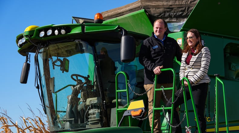 U.S. Secretary of Agriculture Brooke L. Rollins, right, films a social media post on a combine with farm owner Tyler Everett during a farm tour in Lebanon, Ind., Thursday, Oct. 30, 2025. (AP Photo/Michael Conroy)