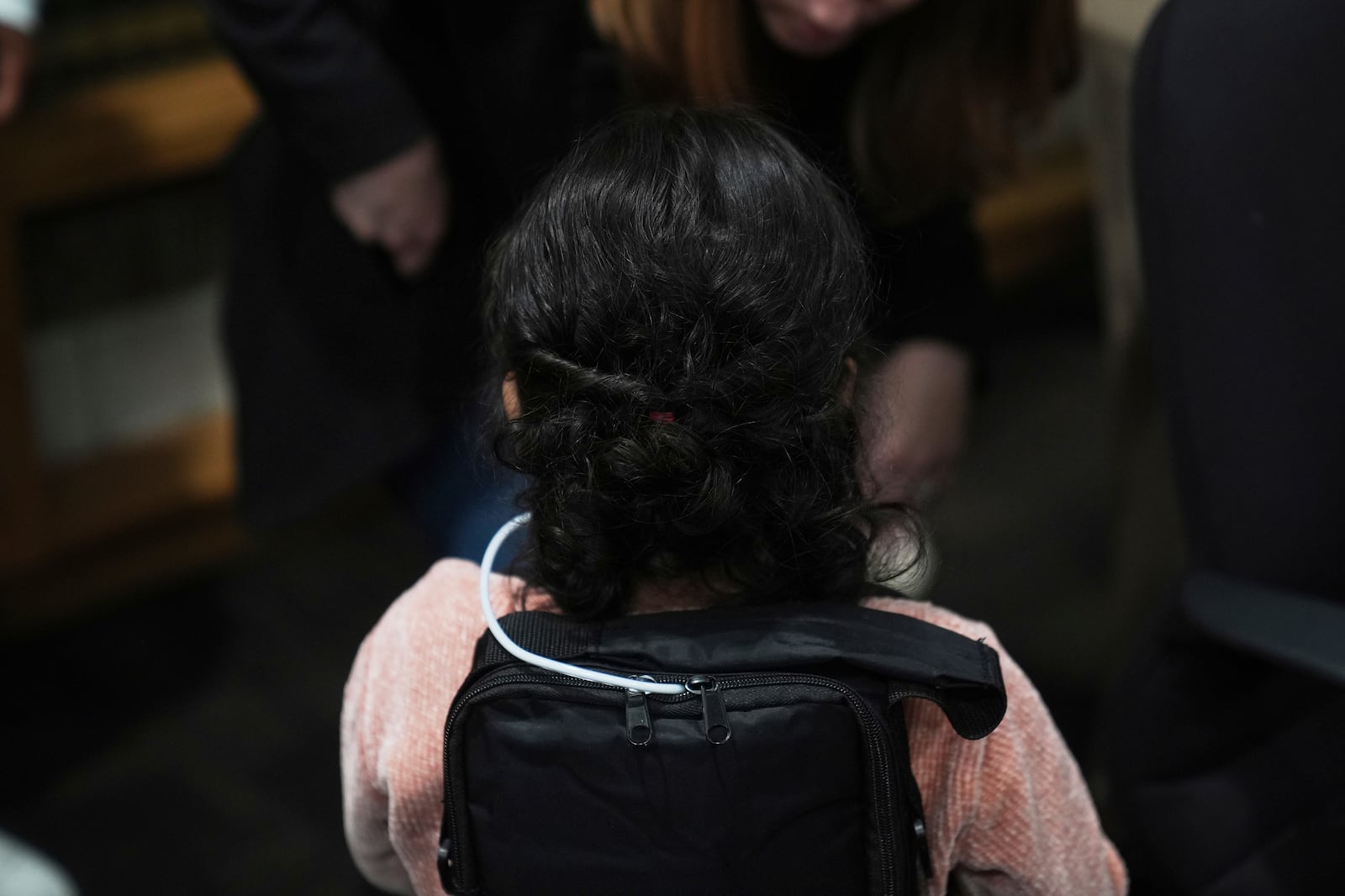 A 4-year-old Mexican girl, who has short bowel syndrome, wears a backpack carrying her medical device at a news conference in Los Angeles, Wednesday, May 28, 2025, after her and her mother's humanitarian parole was terminated and they were ordered to self-deport. (AP Photo/Jae C. Hong)