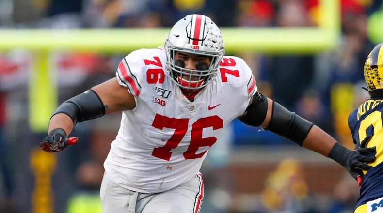 FILE - Ohio State offensive lineman Thayer Munford (75) blocks against Michigan in the second half of an NCAA college football game in Ann Arbor, Mich., in this Saturday, Nov. 30, 2019, file photo. Ohio State stars leaving early for the NFL happens every winter, but perhaps the more surprising news this time is about the number of important players who've decided to stay. Munford said he would be back.  (AP Photo/Paul Sancya, File)