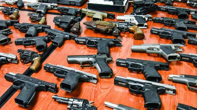 Authorities seized 116 guns of all shapes and sizes, including revolvers, semi-automatic handguns, rifles and one silencer that were displayed in February 2018 at the Butler County Sheriff's Office. NICK GRAHAM/STAFF FILE