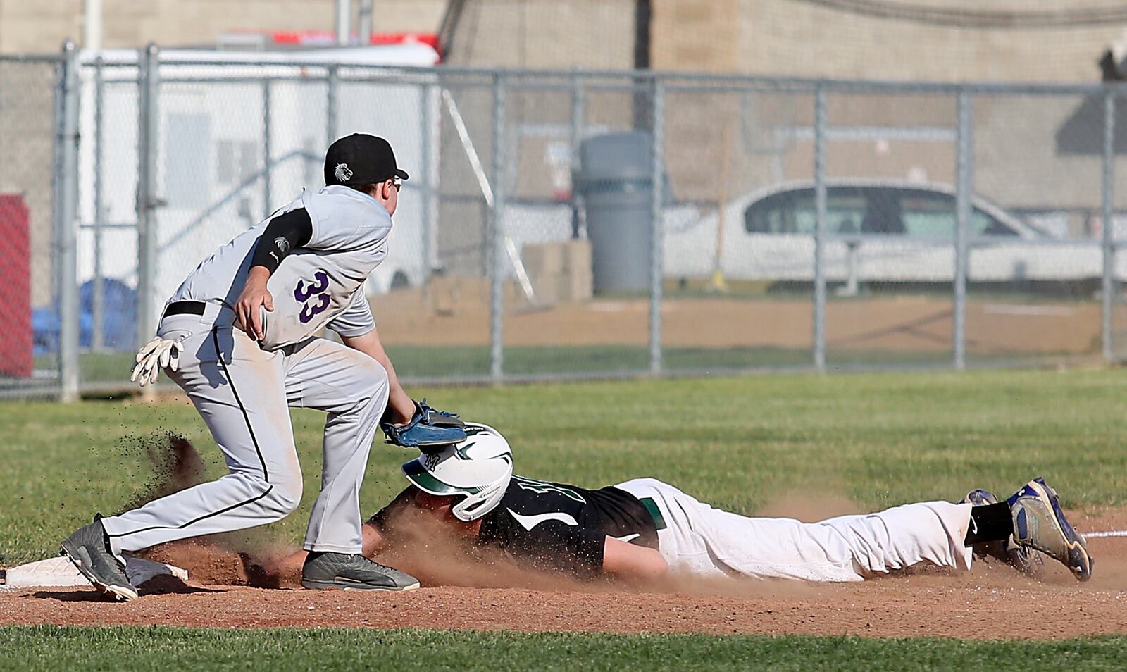 New Miami’s Wayden McIntyre slides under the tag of Miami Valley Christian Academy third baseman Aaron McCoy on Wednesdsay during a Division IV sectional final at Kings. CONTRIBUTED PHOTO BY E.L. HUBBARD
