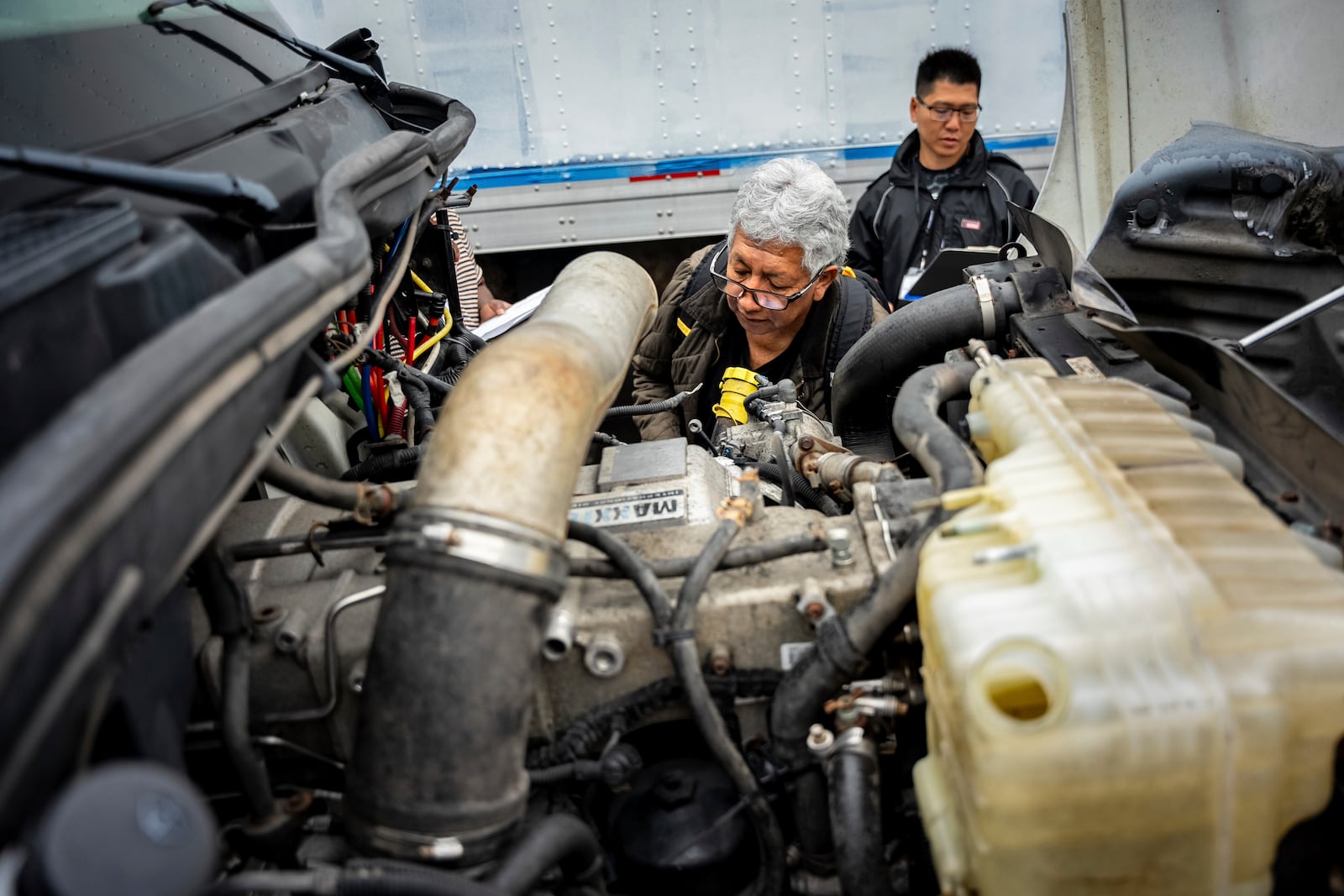 A student studies a truck engine at the Driving Academy on Tuesday, June 10, 2025 in Linden, N.J., where students prepare to obtain a Commercial Driver’s License (CDL) with multilingual instructors. (AP Photo/Angelina Katsanis)