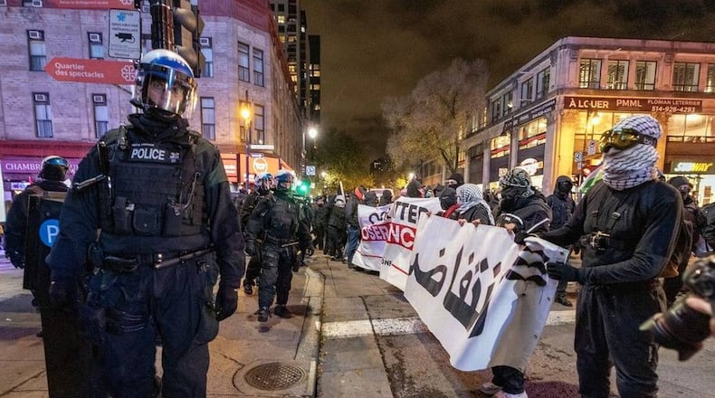 Riot police line the sidewalk on St-Laurent Blvd. in Montreal during protests against the NATO Parliamentary Assembly in November 2024.