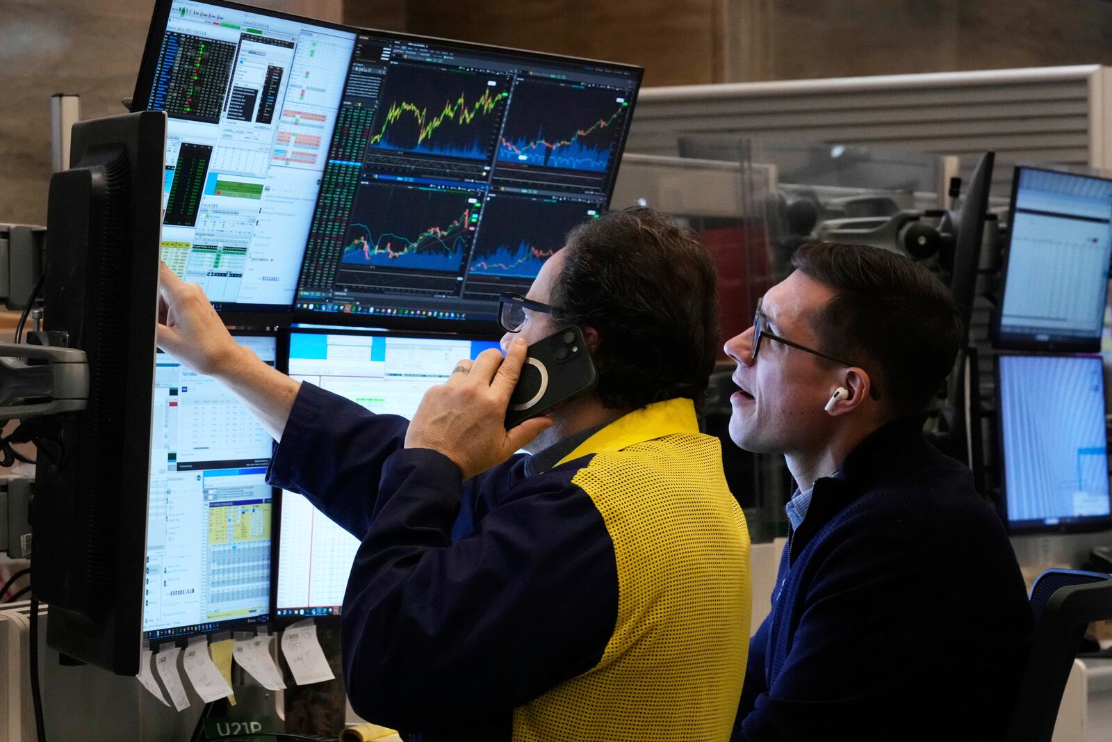 A pair of options traders work on the floor of the New York Stock Exchange, Friday, April 11, 2025. (AP Photo/Richard Drew)