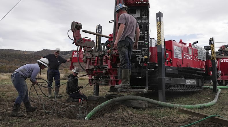 Matt Cooper and his kids Anna, Nathan and Matthew prepare to drill a hole for a geothermal heat pump installation Thursday, Oct. 9, 2025, in Hamilton, Colo. (AP PhotoBrittany Peterson)