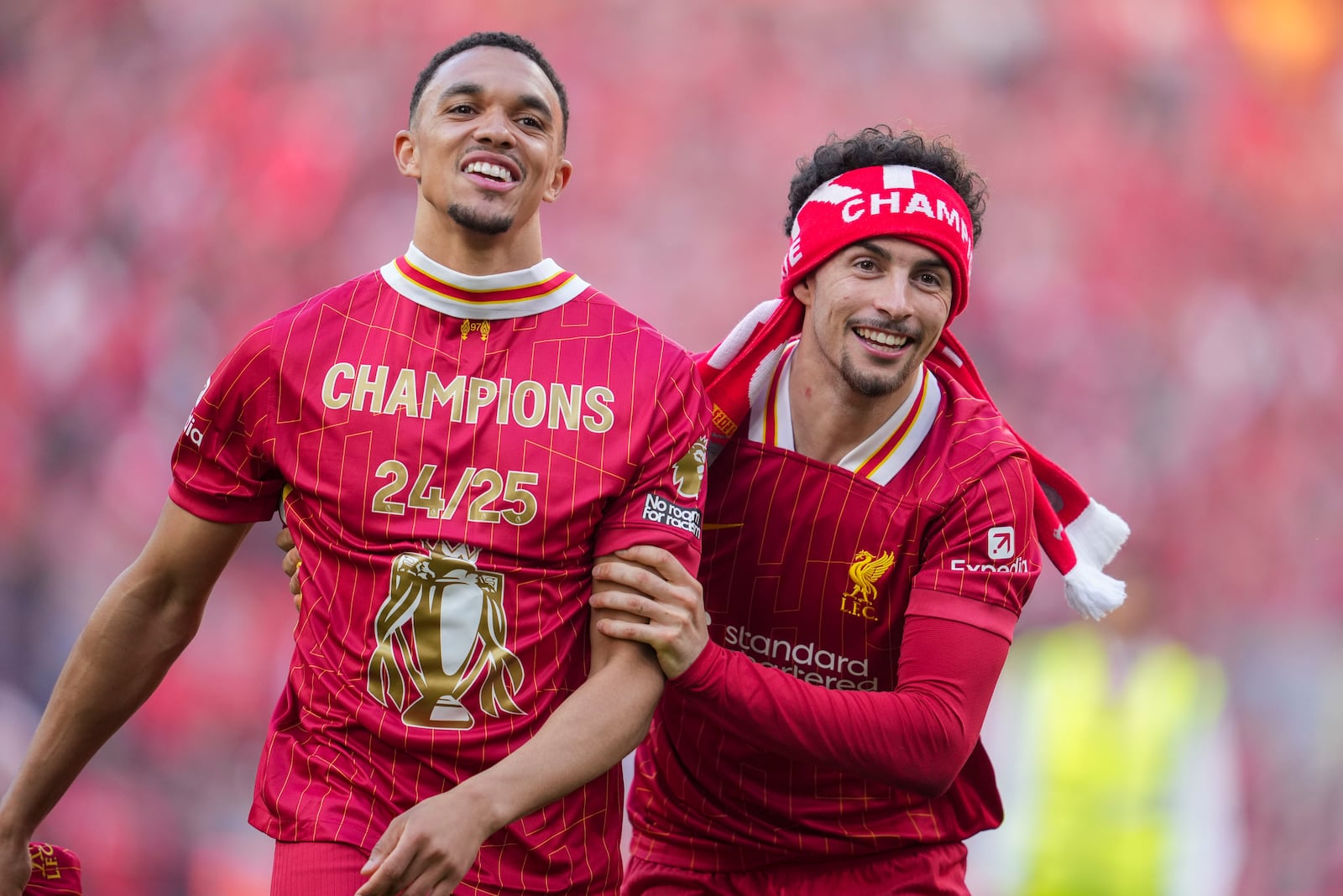 Liverpool's Trent Alexander-Arnold, left, and Curtis Jones celebrate after winning the English Premier League soccer match between Liverpool and Tottenham Hotspur and clinching the Premier League title at Anfield in Liverpool, England, Sunday, April 27, 2025. (AP Photo/Jon Super)